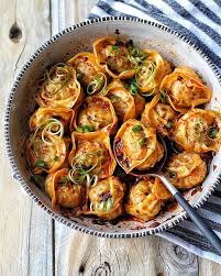 Dumpling is a broad class of dishes that consist of pieces of dough (made from a variety of starch sources) wrapped around a filling, or of dough with no filling. Steamed Wontons In Chili Broth By The Colors Of Yum Quick Easy Recipe The Feedfeed