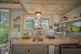 Photo of the loft sleeping area and reading nook inside tiny house. 20 Tiny House Design Hacks Diy