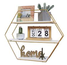 Constructed of gold metal with three wood shelves, this floating shelving can be used to display some books, photos, or knickknacks in your living room or home office. Wholesale Hexagonal Gold Metal Bracket Floating Shelves Solid Wood Shelves For Wall Buy Custom 3 Layers Organize Small Items Natural Wooden Hanging Geometric Decorative Metal Wall Shelf Cheap Bedroom Bathroom Decor White