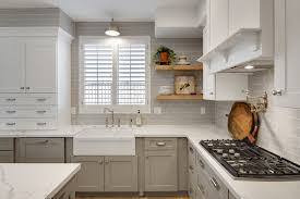 White And Gray Shaker Cabinets With Some Corner Open Shelves And A Gray Tiled Wall Make For A Mode Custom Kitchen Cabinets White Kitchen Decor Shaker Cabinets