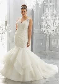 This bridal ball gown is embellished with frosted embroidered lace appliques adorned with crystal beading and features covered button back closures. Plus Size Wedding Dress Collection Mori Lee Aisle Society