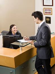 Receptionist Greeting Man At Front Desk Friendly Receptionist Greeting Man At F Sponsored Man Greeting Receptionist F Front Desk Desk Female Images