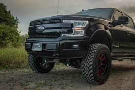 Black And Red Wheels For F150 Front Grill Of A Lifted 2018 Diesel Ford F150 Lariat In Black With Pro Comp 6 In Lift Kit And New Fuel Red Hardline Wheels Ford Trucks F150 Trucks Ford Trucks