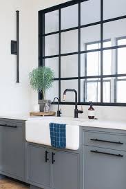 Matte Black Pulls Accent Dark Blue Kitchen Cabinets Topped With A White Quartz Countertop Holding A Far Matte Black Kitchen Black Kitchen Cabinets Black Faucet