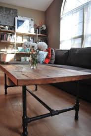 Coffee table recycled hardwood top industrial hand crank iron base. Steampunk Coffee Table