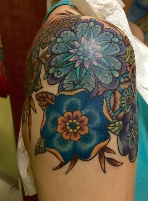 Neotraditional, geometric flower shoulder cap - from Body Art Tattoo in Berryville, VA.