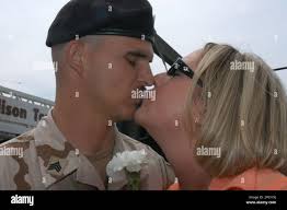 Sgt. Joe Avis, left, kisses his fiancee Sarah Richardson in Adrian, Mich.,  after he returned from Iraq