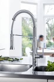 Pairing brass kitchen faucets with hand hammered copper sinks against a clean, white tile backsplash with dark grout for a traditional kitchen design. Kitchen Faucets Buying Guide At Shop Ferguson Com Kitchen Faucet Grohe Kitchen Faucet Black Kitchen Faucets