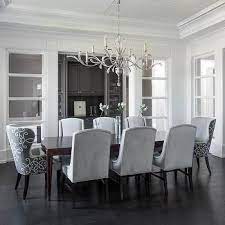 A gray dining chair sits in a corner in front of a wall fitted with white wainscoting and accented with phillip jeffries rivet wallpaper. Pin On Re Living Rooms
