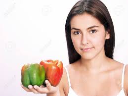 Young Woman Holding A Green And Red Pepper On White Background Stock Photo,  Picture and Royalty Free Image. Image 22580109.