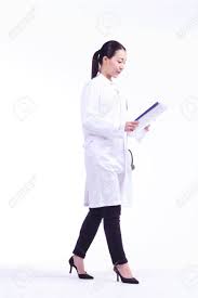 A Femle Doctor Walking As Reading A Chart