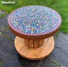 This beer bottle cap table is a great diy project for those who like to create fun and functional works of art. Bottle Cap Resin Coated Cable Reel Table Glasscast
