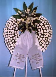 Στεφανια κηδειασ σε τριποδα με νταλιεσ ή γαρυφαλλακαι στο κεντρο συνθεση απο τριανταφυλλα ή ζερμπερεσ. Tripodo Stefani Khdeias Me Kataskeyh An8opwleio Flowershop Gr