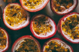 With a sharp knife, cut the fruit in half. Cut Passion Fruit Creating Background By Mosuno