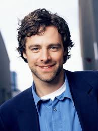 David Sutcliffe young and with beautiful curly hair.