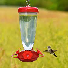 Plastic hummingbird feeders can get damaged by the sun's rays more readily, and are more subject to cracking over time. Duncraft Com Top Fill Red Petunia Flower Hummingbird Feeder