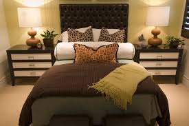 Here, an assortment of patterned pillows, wood tables and sofa legs are a great way to breathe some life into the more neutral gray and beige palette of the sofa and rug. Brown Bed Bedroom Ideas Design Corral