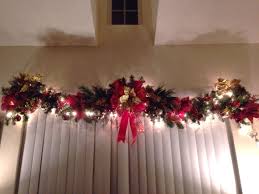 Christmas Garland Above Windows Indoor Red And Gold Lit Poinsettias Christmas Bow Ribbon Christmas Window Decorations Window Garland Diy Christmas Garland