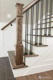 Spindle Staircase Staircase With White Accents And Black Metal Spindles And Shoes Stair Railing Design Entryway Stairs Iron Stair Railing