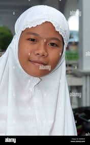 Portrait of an muslim Indonesian girl smiling in Manado Stock Photo