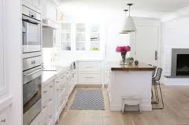 Huge transitional dark wood floor kitchen photo in new york with an undermount sink, shaker cabinets, white cabinets, quartzite countertops, stainless steel appliances. 200 Beautiful White Kitchen Design Ideas That Never Goes Out Of Style