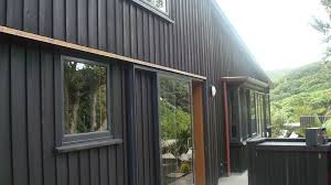 Board And Batten With Resene Stain Piha Black House Exterior Board And Batten Cladding House Cladding