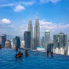 Well, let me tell ya. Infinity Pool In Kuala Lumpur Malaysia Insane City Views In Malaysia View Of Petronas Towers From Above Blue Sky A Travel Travel Inspiration Infinity Pool