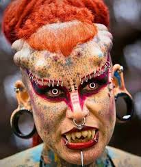 A woman who became a "vampire" by covering entire body in tattoos, reveals  what she looked like before the ink, and you better sit down before seeing  her