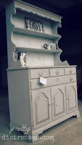 The sideboard table comes complete with four storage drawers, two cabinets, and a bottom shelf. Dry Brush Blog Pretty Distressed Christina Muscari