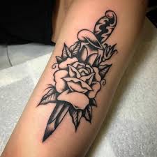 Dagger tattoos are often split in the middle to depict stabbing, and a dagger typically appears to be stabbed through the head of a creature, a flower, a heart, or even the subject's skin. Traditional Tattoo Ideas Meanings Anchors Daggers Flash Ships More