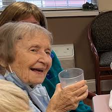 Life Enrichment Assistant Natasha Rosenberg, fulfills her day with many  delightful programs, with her co-workers, but her favorite part is lunch  with our resident's . Seen here with a few Gloria Sostak