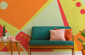 Orange living room walls, white upholstery, black side tables. Orange Wallpaper Wallsauce Au