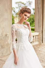 A Line Wedding Dress With Sleeves And Closed Back The Satin Corset Is Covered With A Flickering Embro A Line Wedding Dress Wedding Dresses Tulle Wedding Skirt