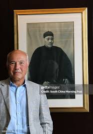 Adrian Fu, Chief executive of KHI Holding Group, stands in front a... News  Photo