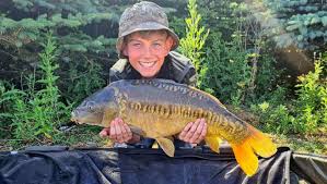Young angler Harry Farrow enjoys a productive session at Bury St Edmunds  Angling Association's Middle Reservoir