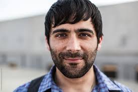 A Man With Dark Hear And Beard Looking Serious Directly Into Camera" by  Stocksy Contributor "J Danielle Wehunt"