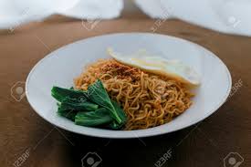 Jika pakai daging mentah, tumis daging juga daging sampai matang. Tasty Fried Noodle Indomie Goreng With Sunny Side Up Egg And Vegetable Served On White Plate Top View Close Up Detail Stock Photo Picture And Royalty Free Image Image 128567189
