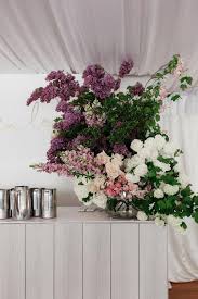 Modern Painterly Wedding With A Custom Justin Timberlake Backdrop Ruffled Beach Wedding Decorations Reception Painterly Wedding Beach Wedding Flowers