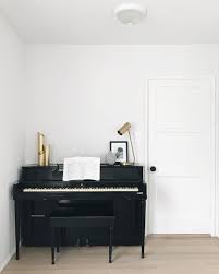 Black Piano In A Minimalist White Living Room With Brass Lamp Minimalist Bedroom Furniture Minimalist Living Room Apartment Minimalist Kitchen Design