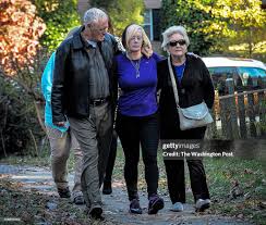 Vikki Moore, center, accompanied by Brendens' grandparents Carl,... News  Photo