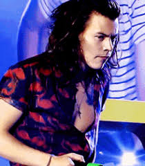 If we're not admiring his dreamy smile or enchanting vocals, then we're definitely looking at that hair. Harry Styles Flipping His Hair Gifs Tenor