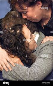 Angela Shepherd, top, and Jennifer Vanover, bottom, embrace Doris Phelps,  Wednesday, March 29, 2006, at the Spotsylvania County Court in  Spotsylvania, Va., after Deanna Large was sentenced to three years in prison