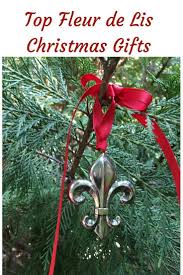 The iconic christmas tree decorated up for santa along with stockings hung by the chimney all wrapped up in a fleur de lis. Ornament Christmas Fleur De Lis Christmas Ornaments Ornaments Christmas