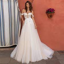 The illusion long bodice with a feminine plunging neckline is embellished with blossoms and shimmering details. Verngo A Line Boho Wedding Dress Elegant Off The Shoulder Wedding Gowns Lace Flower Simple Bride Dress Backless Abito Da Sposa Wedding Dresses Aliexpress