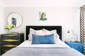 For instance, if you have a modern bedroom set, a white nightstand with clean lines and silver accents will fit in effortlessly. Eclectic White Bedroom With Black Headboard Gold Accented Nightstands And Pops Of Blue Hgtv