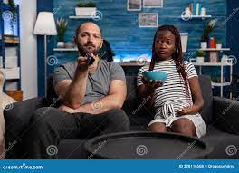 POV of Interracial Couple Watching Television and Relaxing Stock Photo -  Image of interior, relaxing: 228116508