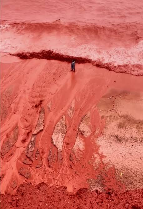 Haunting moment 'blood rain' weather phenomenon turns beach bright RED