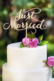 We love the idea of displaying a mini version of your wedding cake design with a cake topper and then using the same topper for the larger cake on your wedding day. Wood Wedding Cake Topper Rustic Monogram Mr Mrs Love Heart Cake Topper Wedding Cake Toppers Home Garden