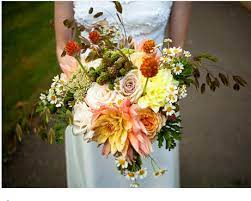 Filled with rich colors and textures, these gorgeous arrangements of fall flowers truly capture the spirit of the season—not to mention the romance of your wedding day. Peaches And Dreams Dahlias Red Clovers Rattle Grass Geraniums Caramel Antique Garden Roses Metalina Fall Wedding Flowers Wedding Flowers Wedding Bouquets