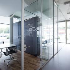 Closed room with white armchairs and table with computer. All Glass Door